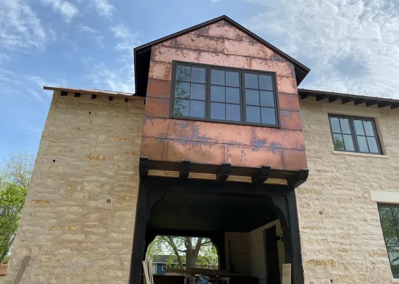 Copper metal panel facade on a stone building for Skylight Installation in El Segundo